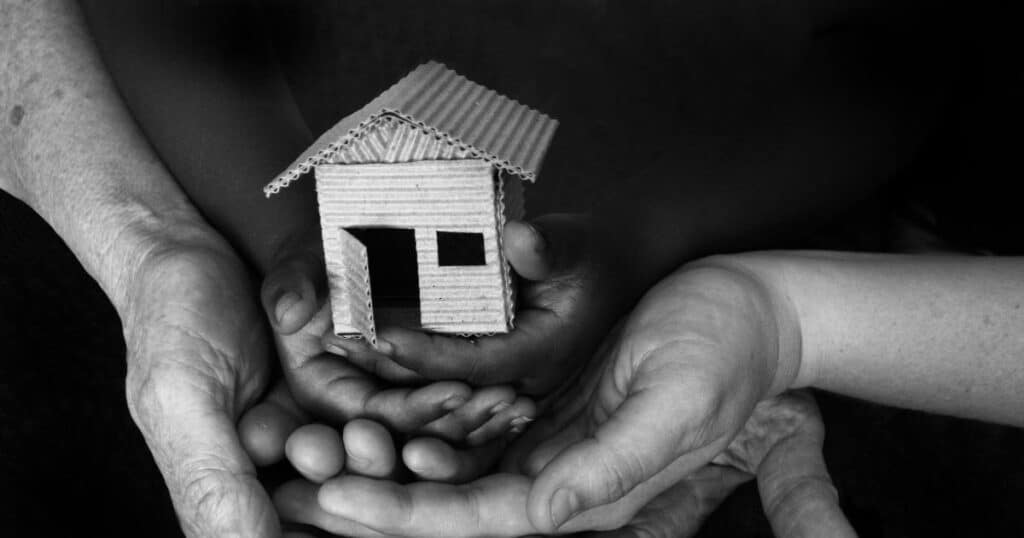 mental health - holding tiny house in hands